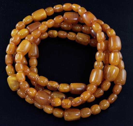A long single strand amber necklace, with oval and barrel shaped beads, gross weight 192 grams, 160cm.